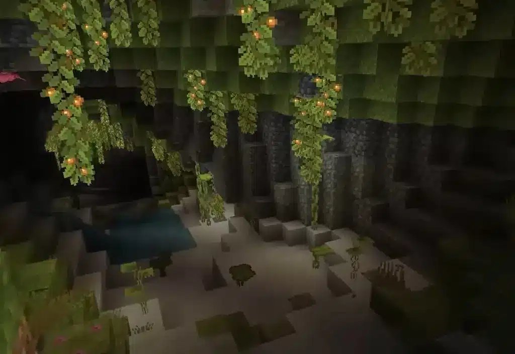 A view of a Lush Caves biome in Minecraft, featuring hanging glow berries and greenery.