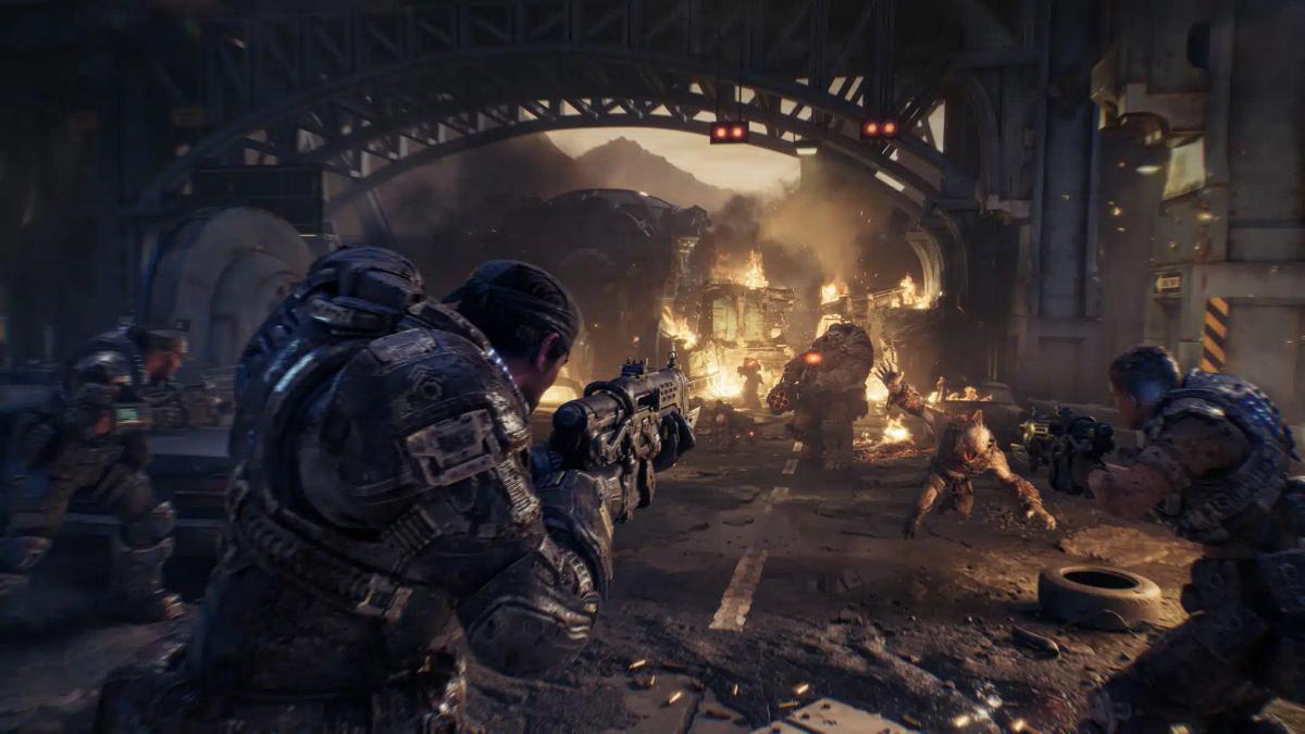 Soldados com armaduras pesadas enfrentando monstros em um ambiente urbano em ruínas de Gears of War: E-Day.